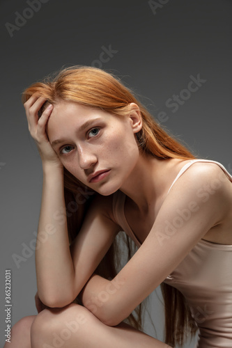 Youth. Fashion portrait of beautiful redhead woman isolated on grey studio background. Concept of beauty, skin care, fashion and style. Artwork, modern and trendy portrait. Attractive model.
