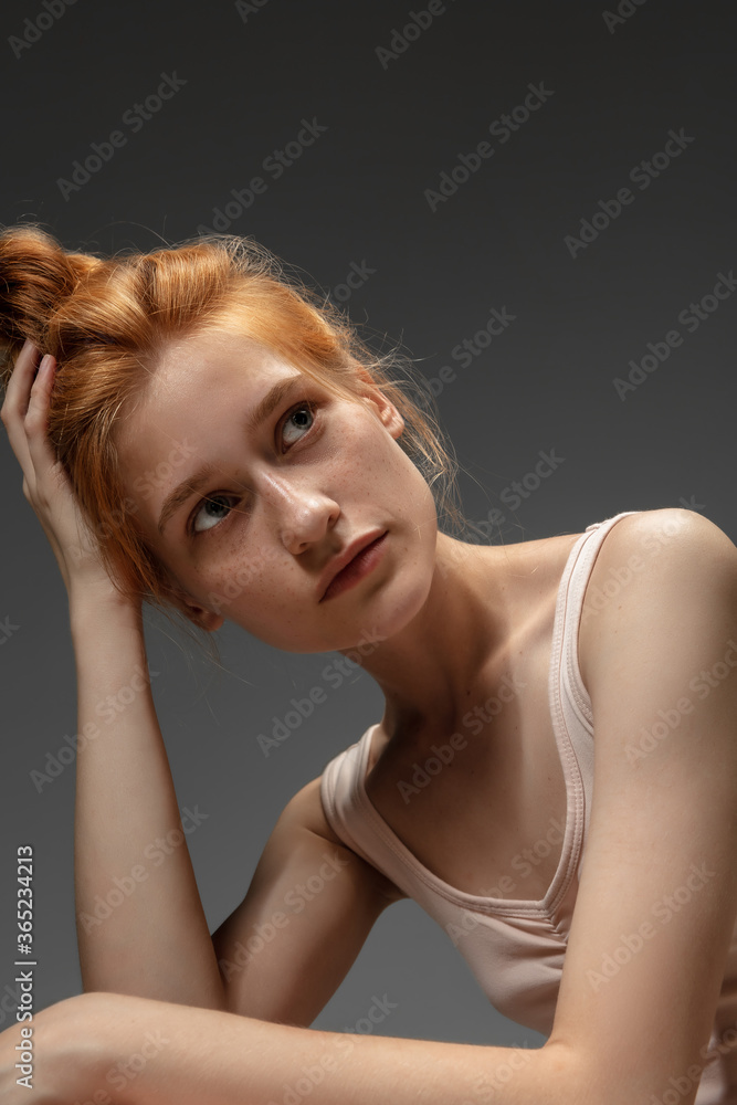 Thoughts. Fashion portrait of beautiful redhead woman isolated on grey studio background. Concept of beauty, skin care, fashion and style. Artwork, modern and trendy portrait. Attractive model. Thoughts. Fashion portrait of beautiful redhead woman isolated on grey studio background. Concept of beauty, skin care, fashion and style. Artwork, modern and trendy portrait. Attractive model.