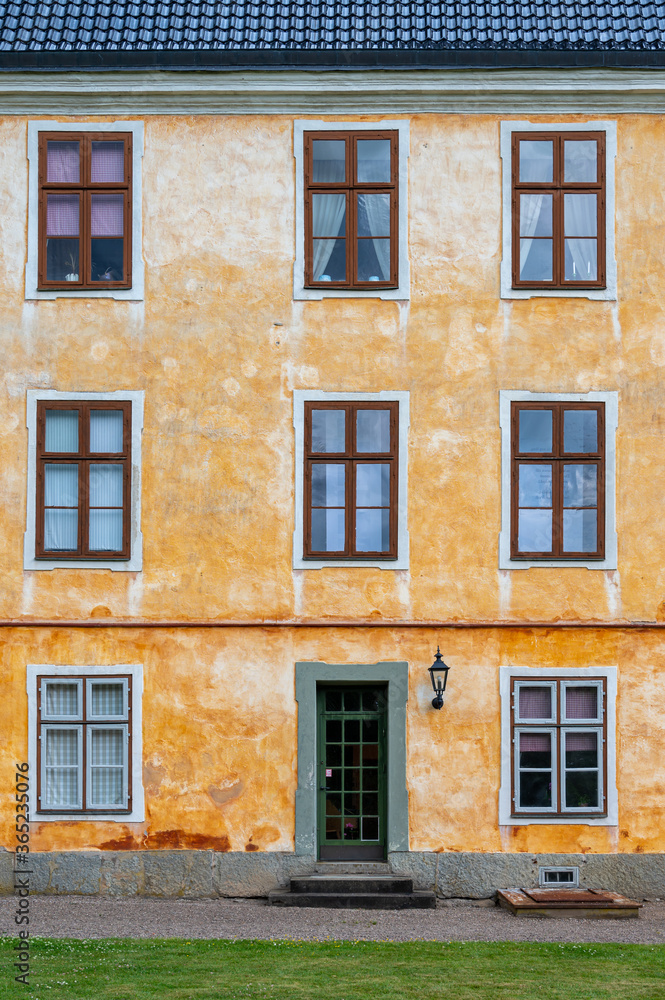A yellow and orange facade of an old medieval building
