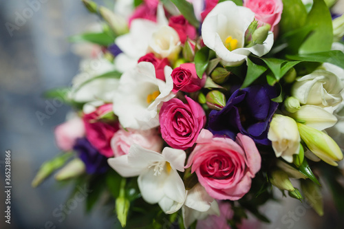 Close-up photo of a bridal bouquet  white  purple and pink flowers.