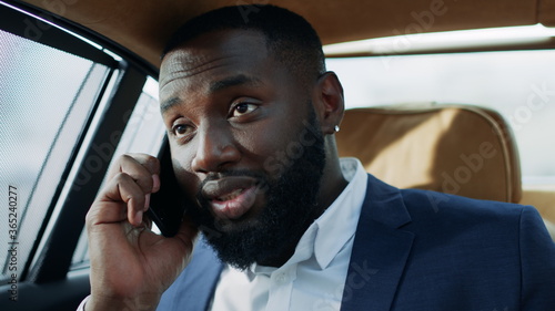 Tired african american man talking mobile phone in vehicle. Happy man face © stockbusters