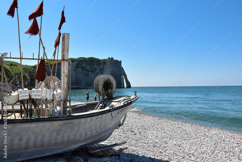 Fishing boat on the beach near the famous cliffs of Etretat, Normandy ...
