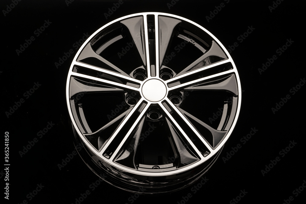 Fototapeta premium black alloy wheel on dark background close up