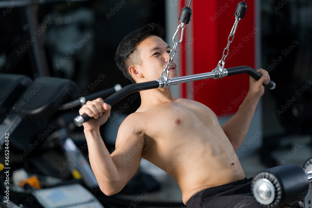 Sporty man training doing exercise in fitness gym Sporty man training doing exercise in fitness gym