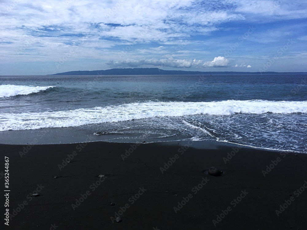 Asian country Indonesia. Bali island. Nusa penida, black sand beach and ocean Asian country Indonesia. Bali island. Nusa penida, black sand beach and ocean