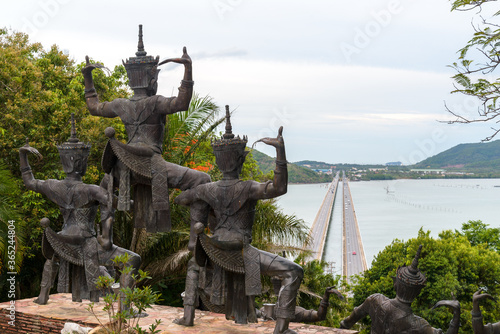 Manora Statue (a kind of Thai-style dancing) facing to the bridge across the lagoon near museun in Songkhla, Thailand photo