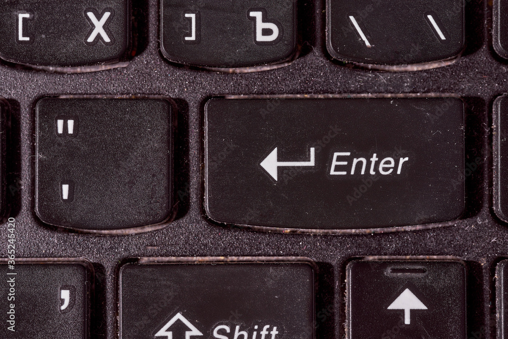 A computer keyboard. Focus on enter button. Black background A computer keyboard. Focus on enter button. Black background