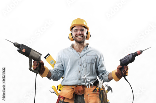 Fotografia Construction worker in dirty clothes with a hammer and drill at work
