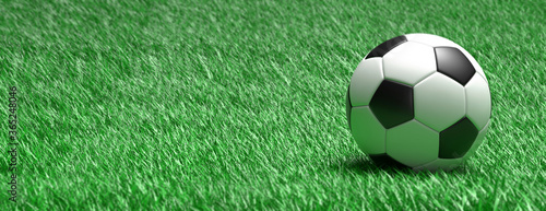 Soccer ball, football close up view, green grass field background. 3d illustration