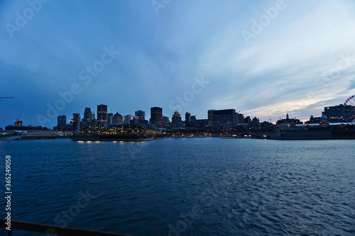 Montreal Downtown skyline during the twilight blue hour. Foreground is Saint Laurent river. © Rania