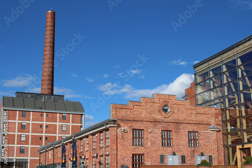  red brick factory building with a tall chimney in Lahti. Finland. photo