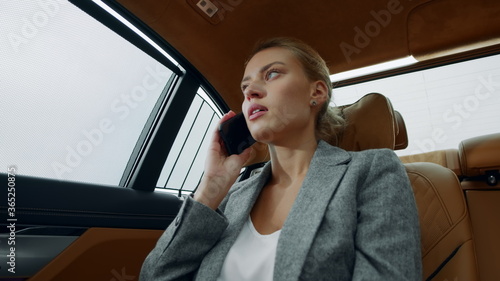 Angry woman calling mobile phone at car. Businesswoman talking phone at vehicle © stockbusters