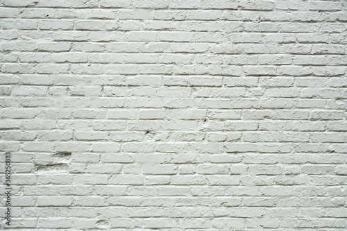 Background image of a roughly textured brick wall painted white 