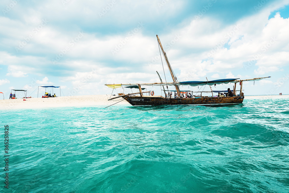 Boat near sand bank in ocean in Zanzibar