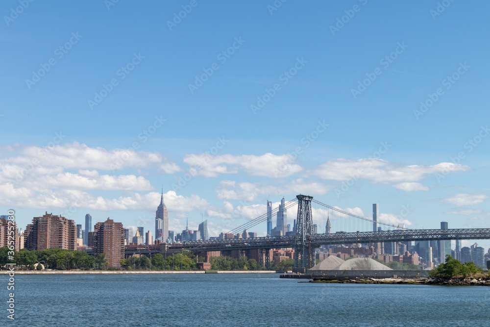 Manhattan Skyline along the East River with the Williamsburg Bridge in New York City