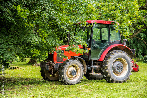 Large red tractor on the farm. Agriculture. Technology . 