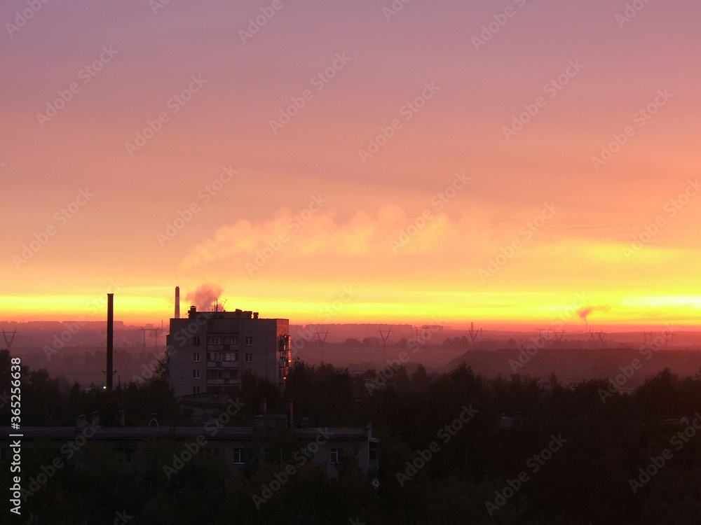 Red-orange-violet sky and dawn in the city suburb