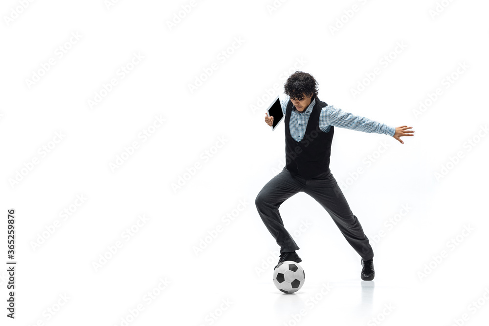 Man in office clothes playing football or soccer with ball on white background like professional player. Unusual look for businessman in motion, action kicking ball. Sport, healthy lifestyle Man in office clothes playing football or soccer with ball on white background like professional player. Unusual look for businessman in motion, action kicking ball. Sport, healthy lifestyle
