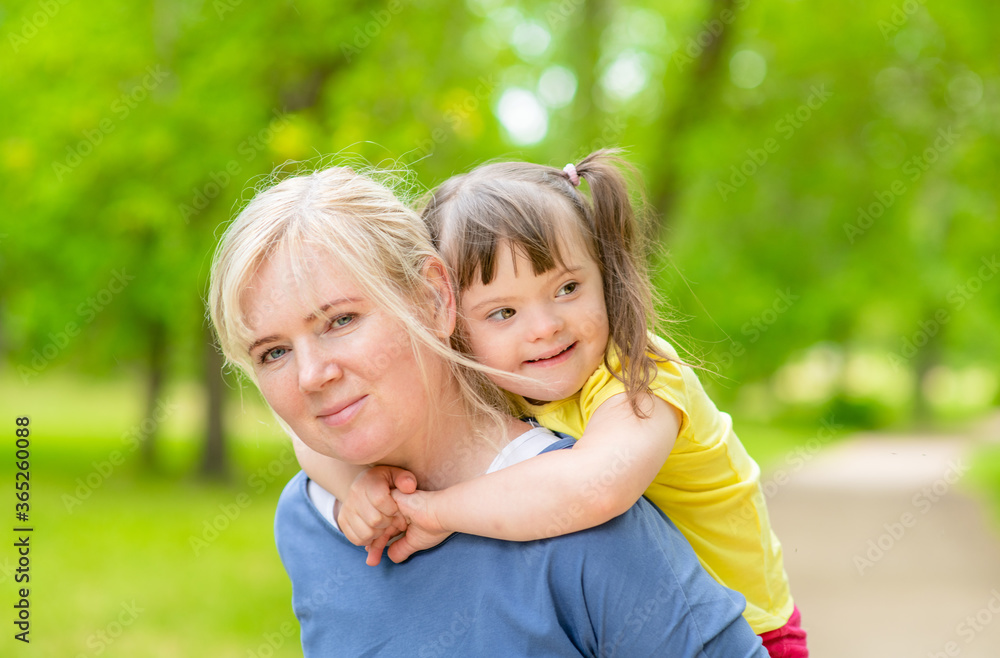 Portrait of a mother and little girl with special needs in summer park Portrait of a mother and little girl with special needs in summer park