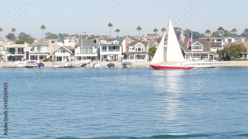 Newport beach harbor, weekend marina resort with yachts and sailboats, Pacific Coast, California, USA. Waterfront luxury suburb real estate in Orange County. Expensive beachfront holiday destination