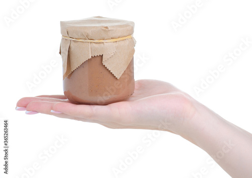 Jar of pate in hand on white background isolation