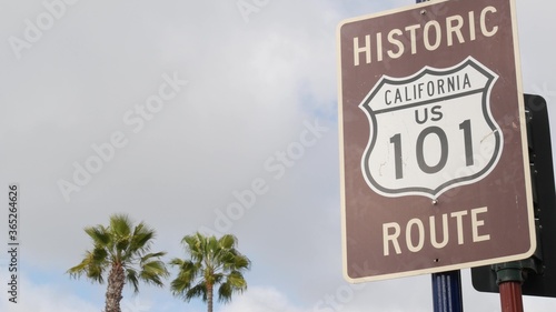Pacific Coast Highway, historic route 101 road sign, tourist destination in California USA. Lettering on intersection signpost. Symbol of summertime travel along the ocean. All-American scenic hwy photo