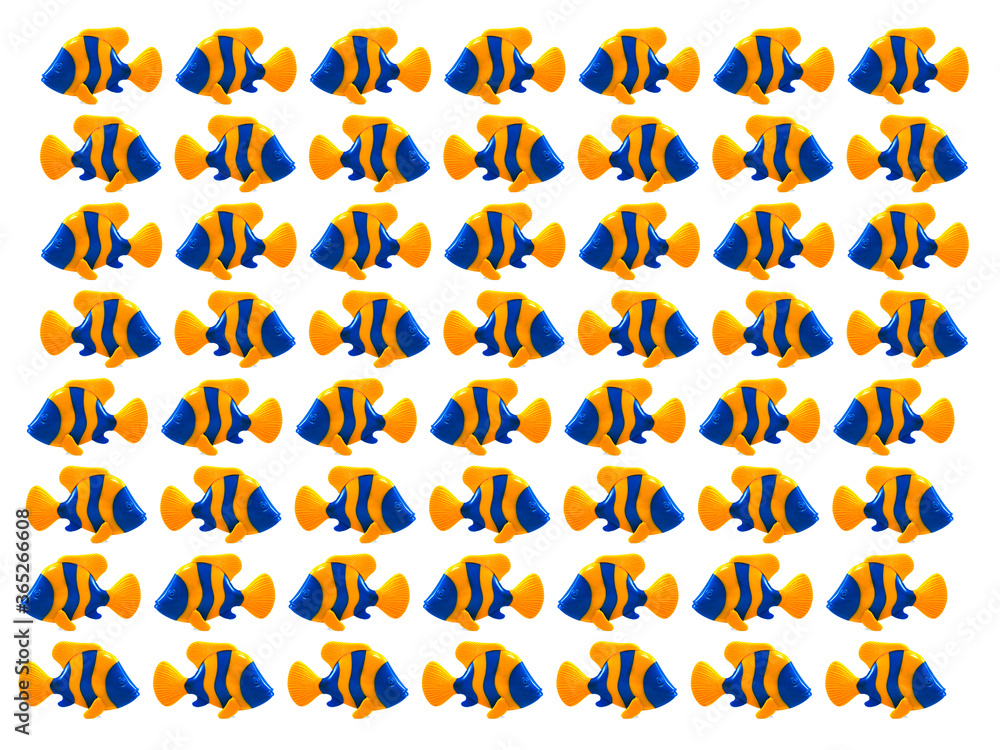 Photo of lots of toy Fish made of plastic. Background pattern, cloned, studio shot. Colored background. Photo of lots of toy Fish made of plastic. Background pattern, cloned, studio shot. Colored background.