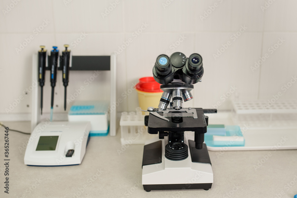 laboratory equipment: medical microscope, micropipette, and urine strip analyser laboratory equipment: medical microscope, micropipette, and urine strip analyser