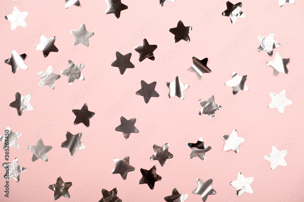 Pastel rose color festive background with silver stars glitter confetti. Flat lay style with copy space for text, design. Trendy Holiday concept. Perfect pink backdrop for social media, blog, postcard Pastel rose color festive background with silver stars glitter confetti. Flat lay style with copy space for text, design. Trendy Holiday concept. Perfect pink backdrop for social media, blog, postcard