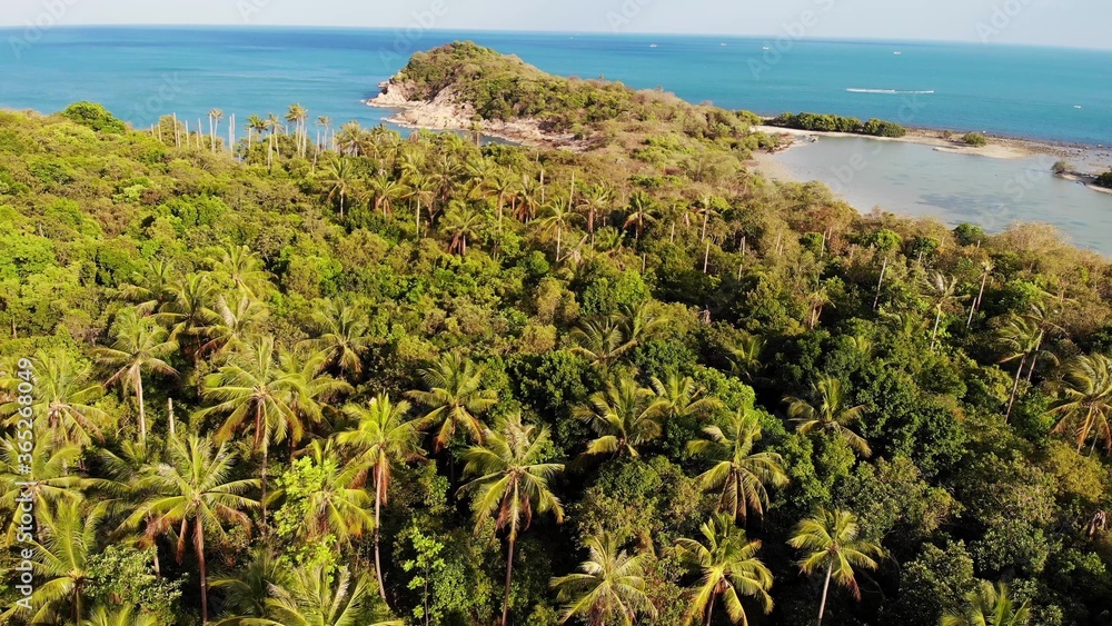 Small island and coral reef in ocean. Drone view of green uninhabited island and amazing coral reef in calm sea on sunny day in tropical nature. Koh Samui, Thailand. Small island and coral reef in ocean. Drone view of green uninhabited island and amazing coral reef in calm sea on sunny day in tropical nature. Koh Samui, Thailand.