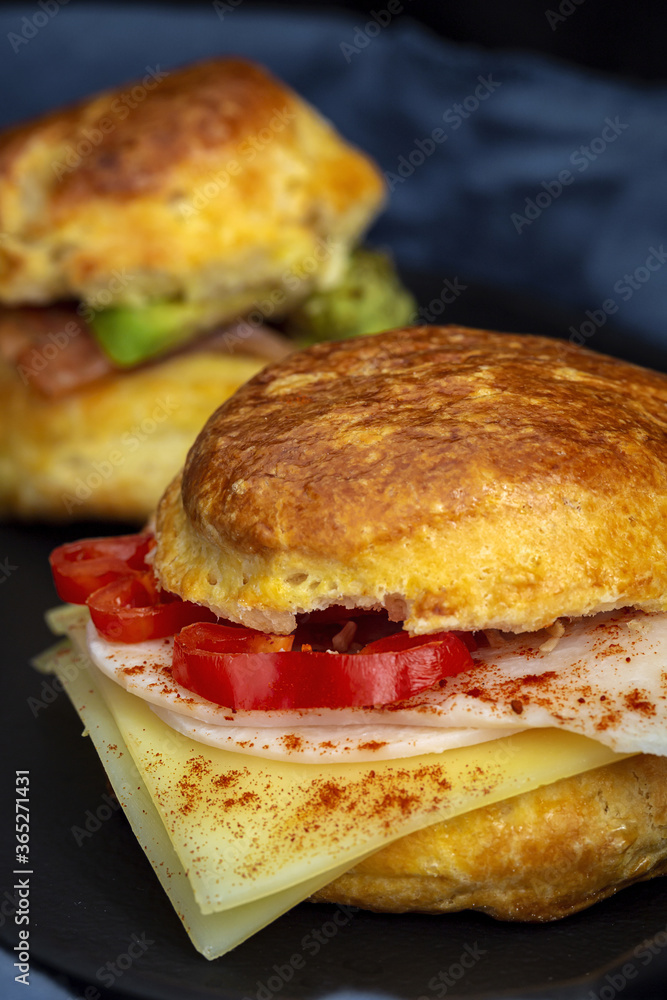 Assortment of homemade scones with ham, cheese, avocado, salmon, cream cheese and strawberry jam Assortment of homemade scones with ham, cheese, avocado, salmon, cream cheese and strawberry jam