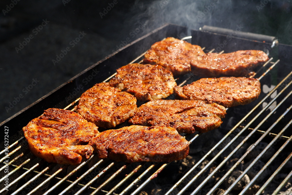 Pieces of neck on the grill, freshly grilled crispy meat, golden-brown color