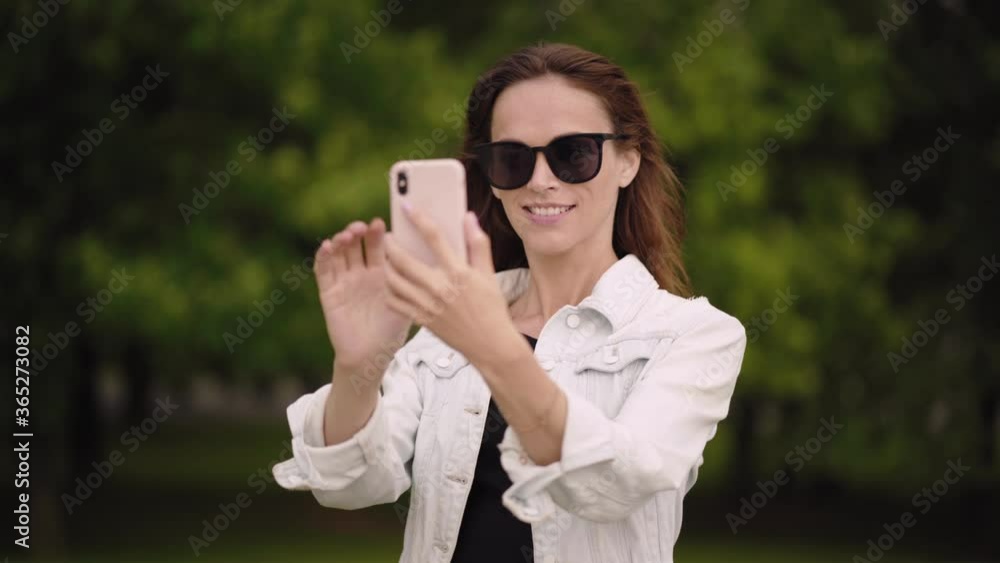 Beautiful woman is taking selfie on her smartphone Beautiful woman is taking selfie on her smartphone