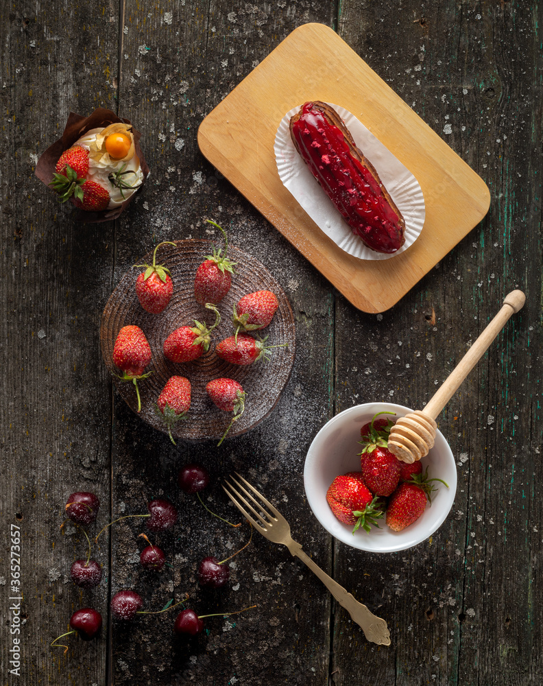 Styling strawberrie and cherry on wood background