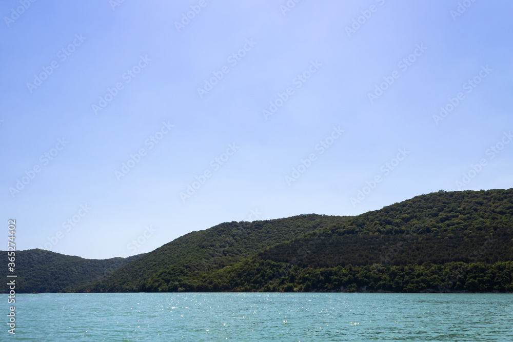 azure, lake, against backdrop mountains covered forest
