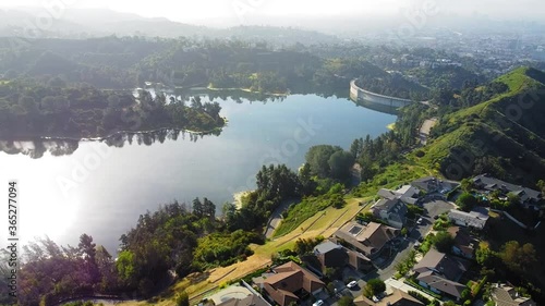 Stunning birds-eye-view over the Hollywood Reservoir. Bright morning with the sun's reflection on the water. Gliding shot