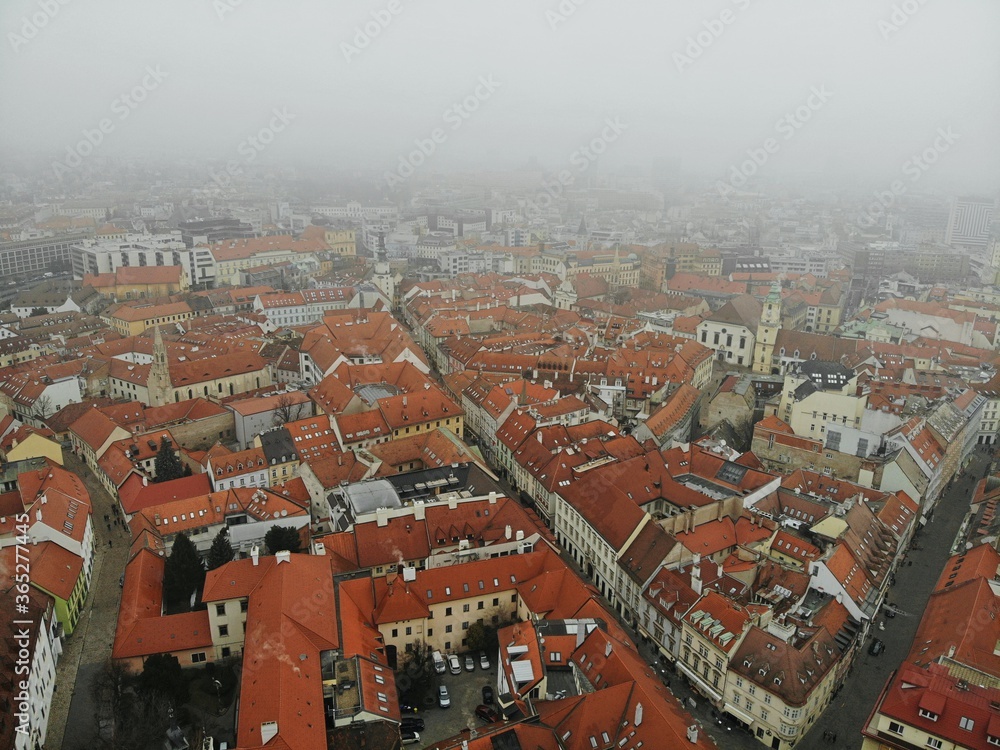 Obraz premium Slovakia, Bratislava. Historical old city centre. Aerial view from above, created by drone. Foggy day town landscape, travel photography.