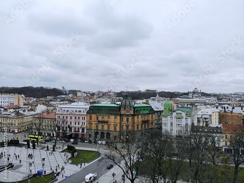 Aerial view from above of Lviv city, Ukraine. Beautiful drone photography. Ancient sculpture on rooftop of house