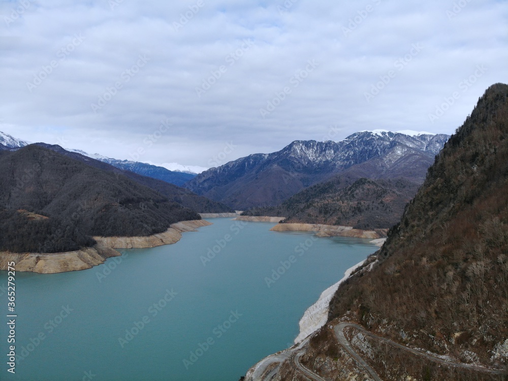 Georgia. The Enguri Dam is a hydroelectric arch dam. View from above, perfect landscape photo, created by drone. Aerial photo, mountain and river view.