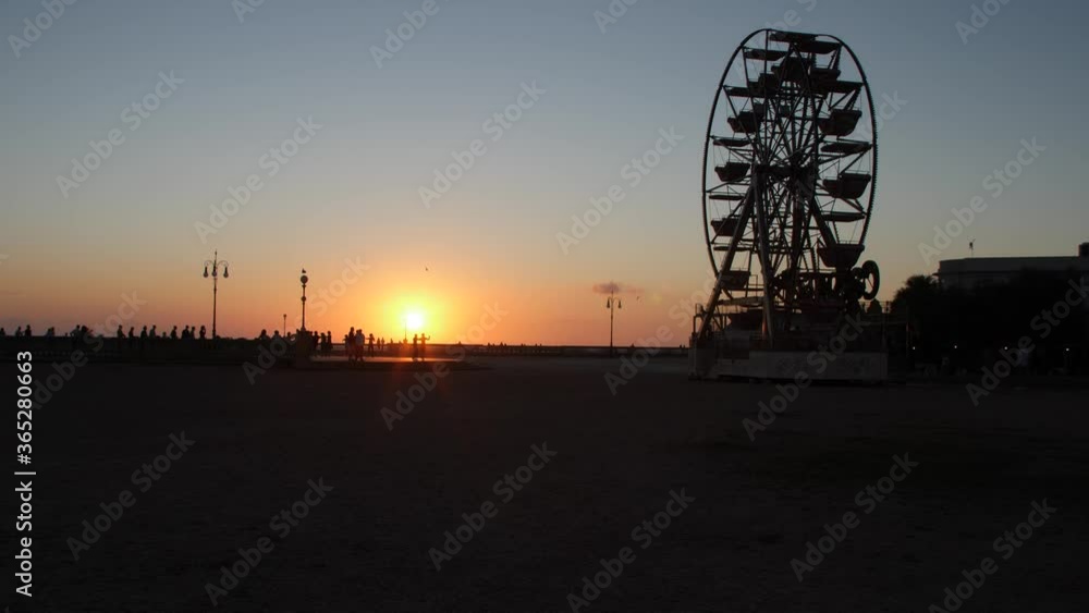 Ferris Wheel Spinning, Couples Dancing on a Terrace at Sunset and Seagulls Ferris Wheel Spinning, Couples Dancing on a Terrace at Sunset and Seagulls