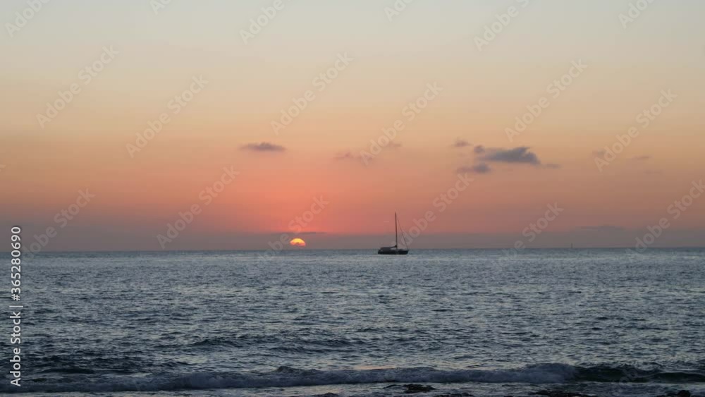 Silhouette of White Sailboat sailing in the Sea at Sunset. Silhouette of White Sailboat sailing in the Sea at Sunset.