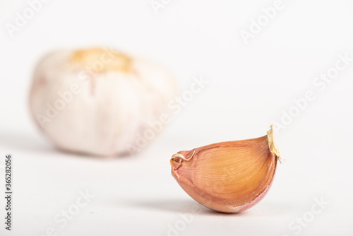 Garlic clove with shell on white background
