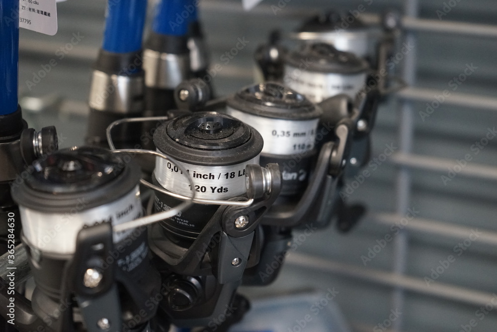 Fishing Rod, spinnings reels in the store. Close-up photo Fishing Rod, spinnings reels in the store. Close-up photo