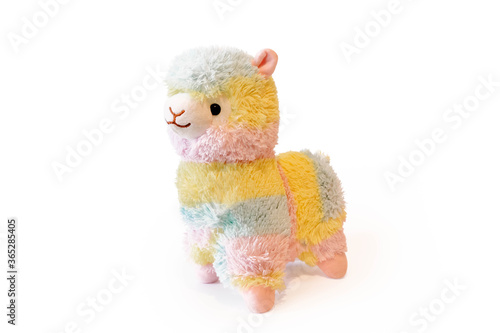 Soft alpaca plushie doll alpaca toy isolated on white background with shadow reflection. The concept of gifts for the holidays. Toy in the shape of an animal.