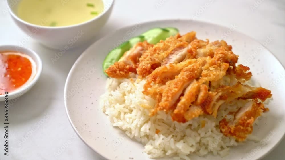 Hainanese chicken rice with fried chicken or rice steamed chicken soup with fried chicken - Asian food style Hainanese chicken rice with fried chicken or rice steamed chicken soup with fried chicken - Asian food style