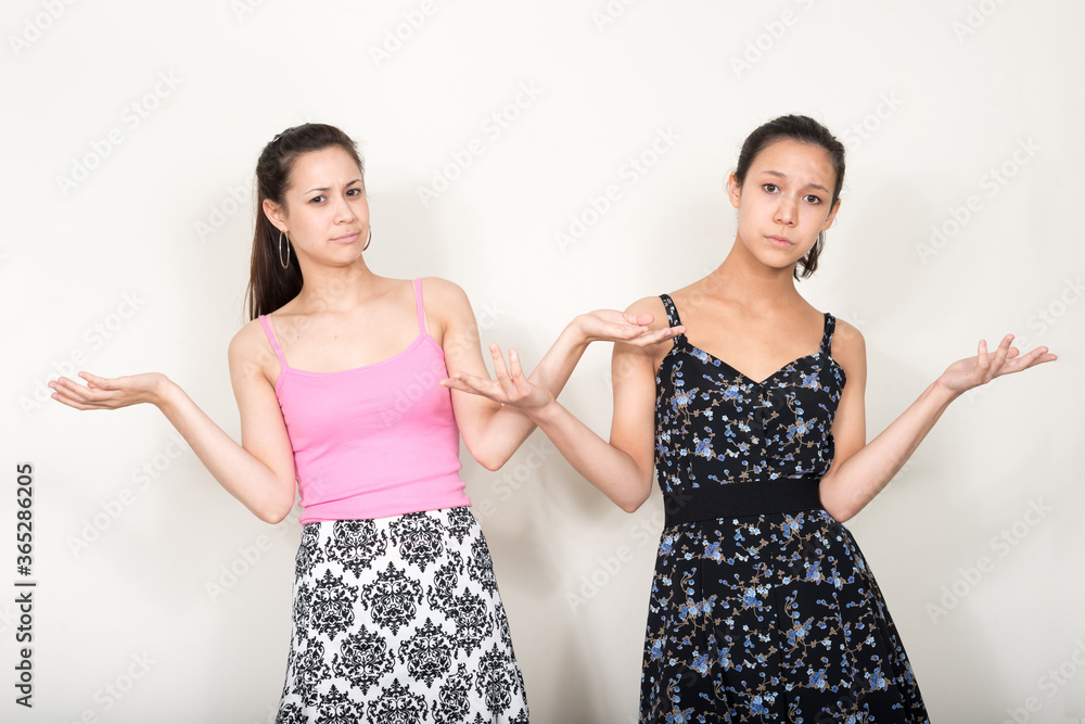 Portrait of two young beautiful women as sisters together Portrait of two young beautiful women as sisters together