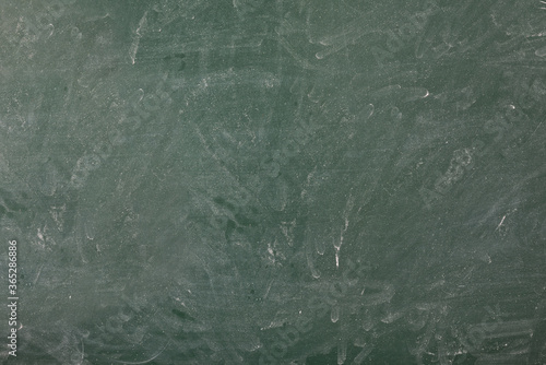Erased and dirty green college blackboard with space to write