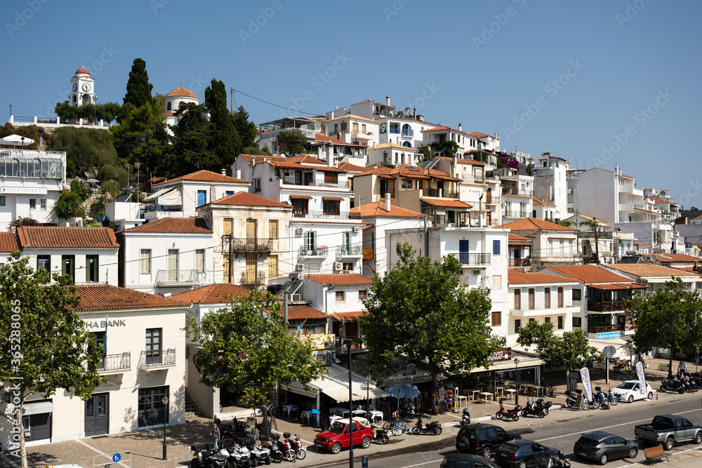 The historical town on Skiathos island seen from the boat when entering the harbour in summer light.