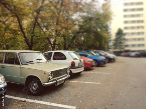 Old car in a parking lot in a modern city © Alex