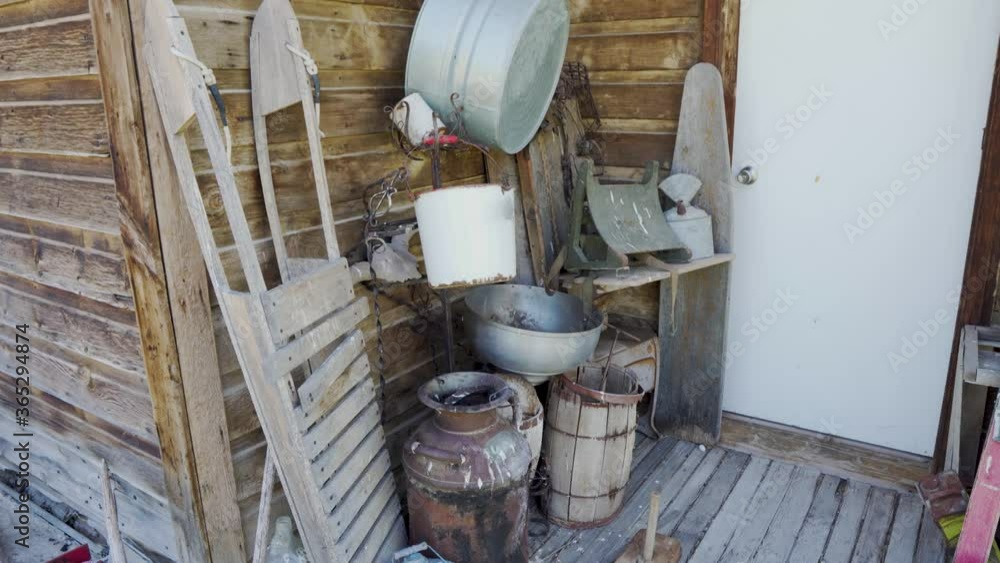 Antique items on the back porch of an old abandoned cabin in the old west Antique items on the back porch of an old abandoned cabin in the old west